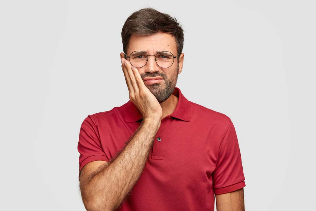 A Guy in Red T-shirt Having Tooth Pain