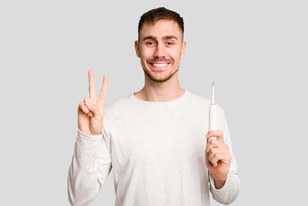Man in White T-shirt Smiling & Holding Toothbrush in Hand