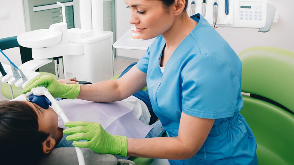 Dentist Performing Sedation Dentistry Procedure On Patient