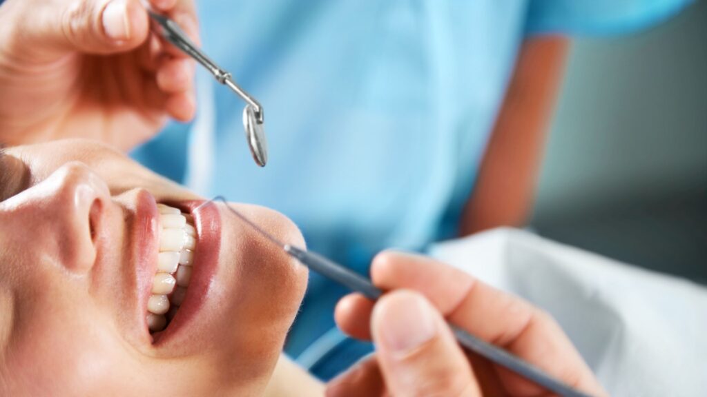 A Dentist Treating Patient Teeth