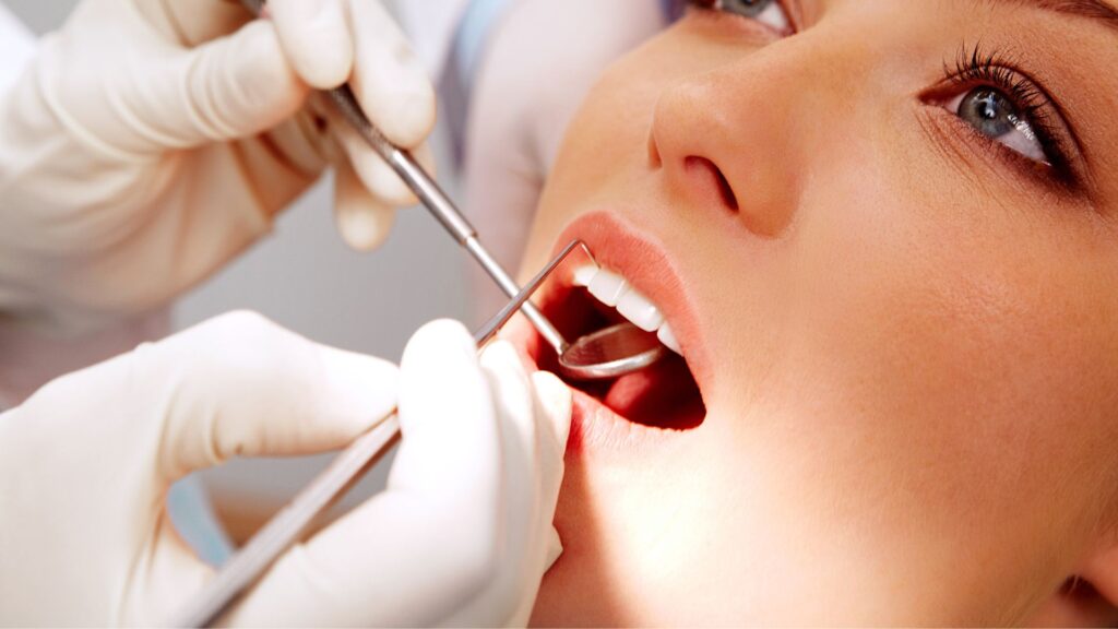 Dentist Examining A Person's Teeth