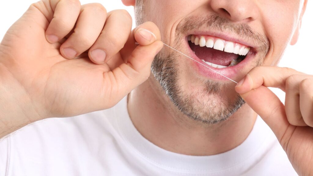 Person Flossing His Teeth