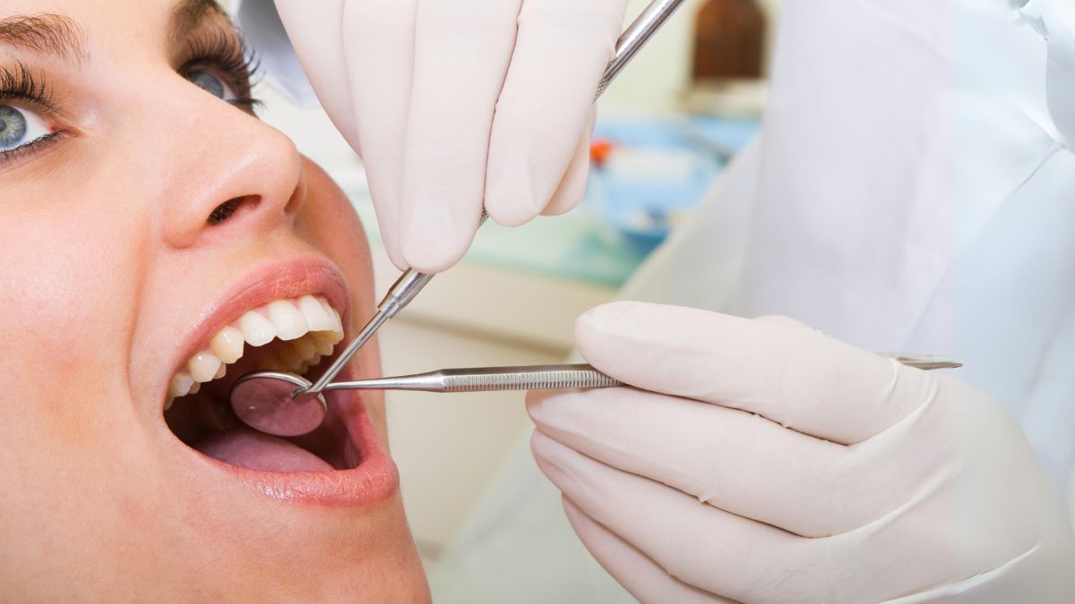 A Dentist Examining a Woman's Teeth
