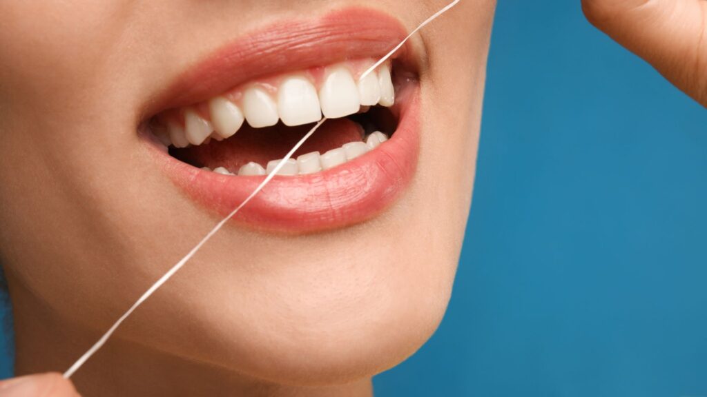 Woman Flossing Teeth