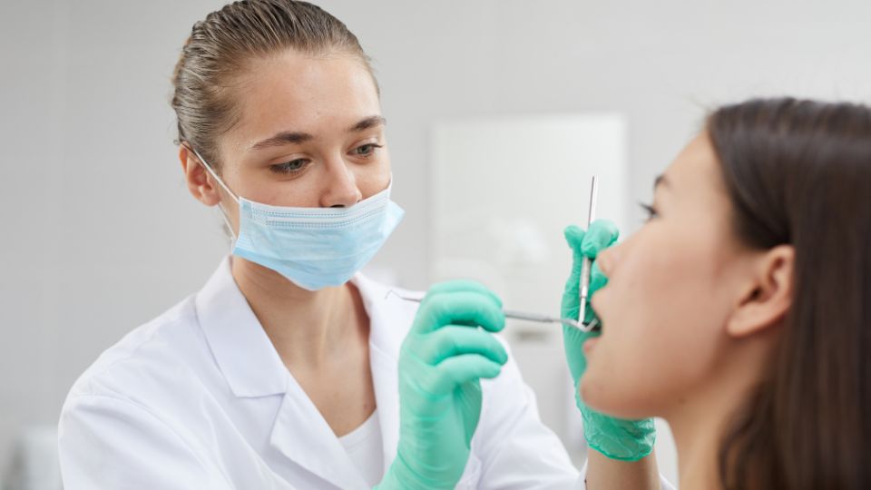 Woman Getting Oral Checkup by Dentist