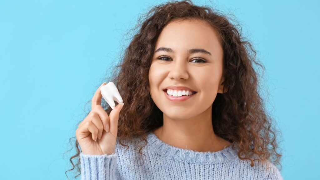 Woman Holding a Dummy Tooth