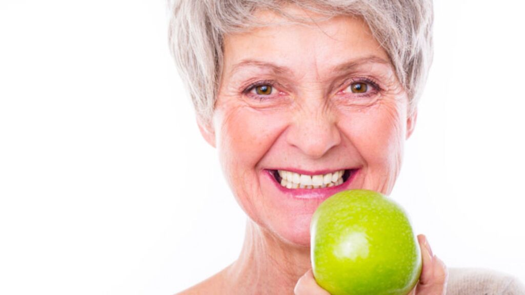 Senior Woman Holding A Green Apple