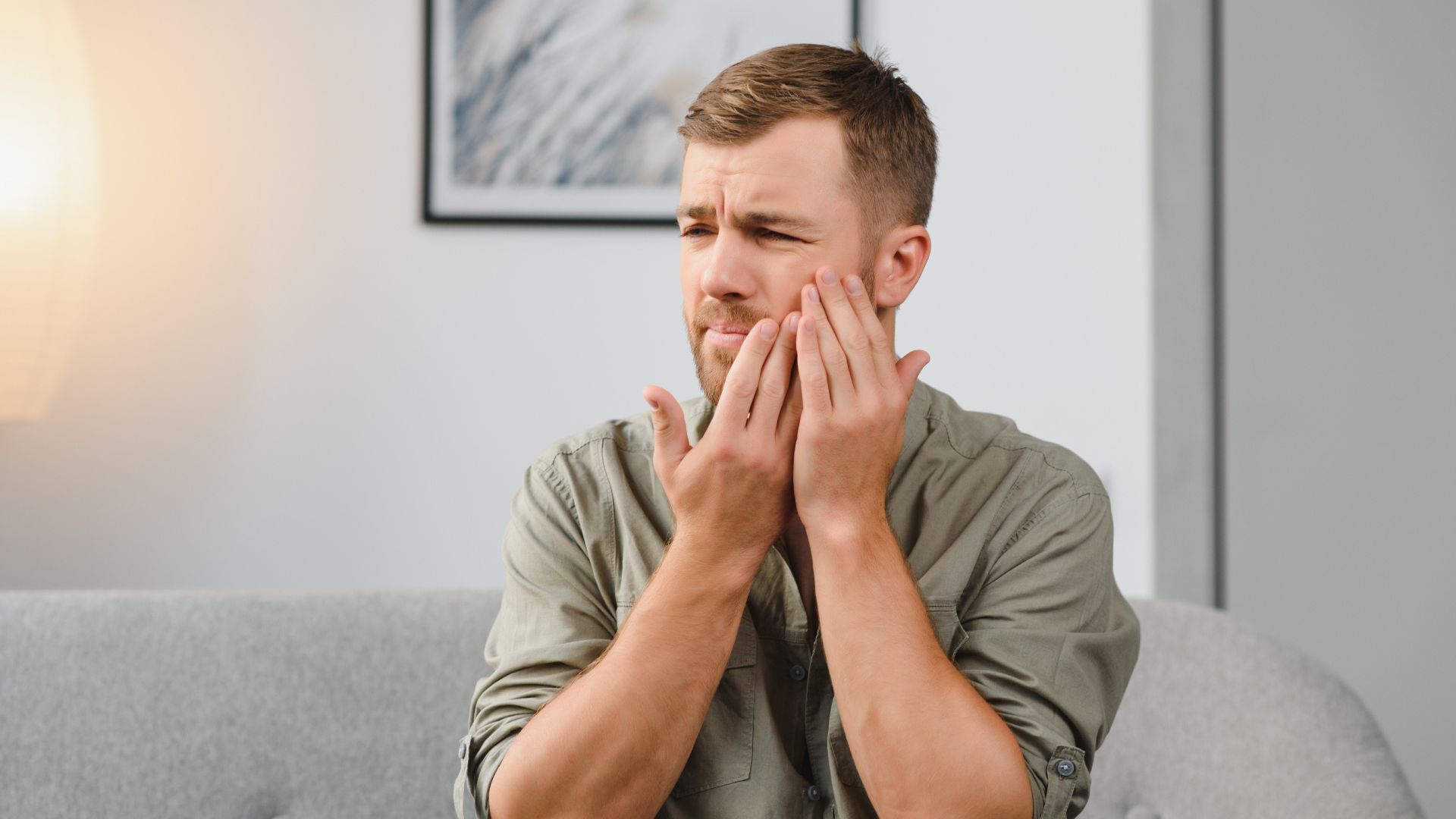 Man Holding Jaw In Tooth Pain